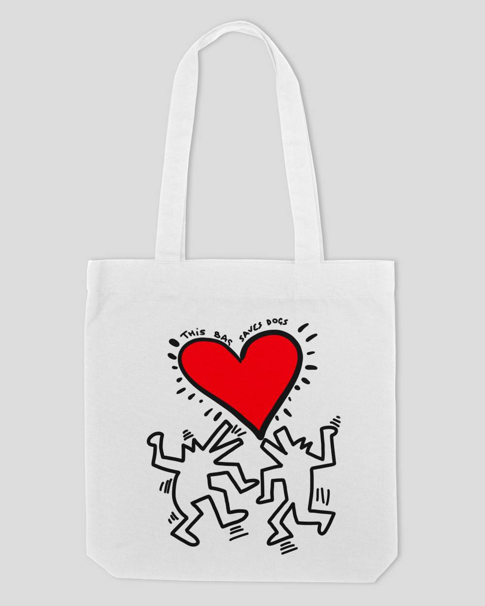 This is a white tote bag with a design of two dogs and a heart in the style of Keith Haring, this bags design says this bag saves dogs.