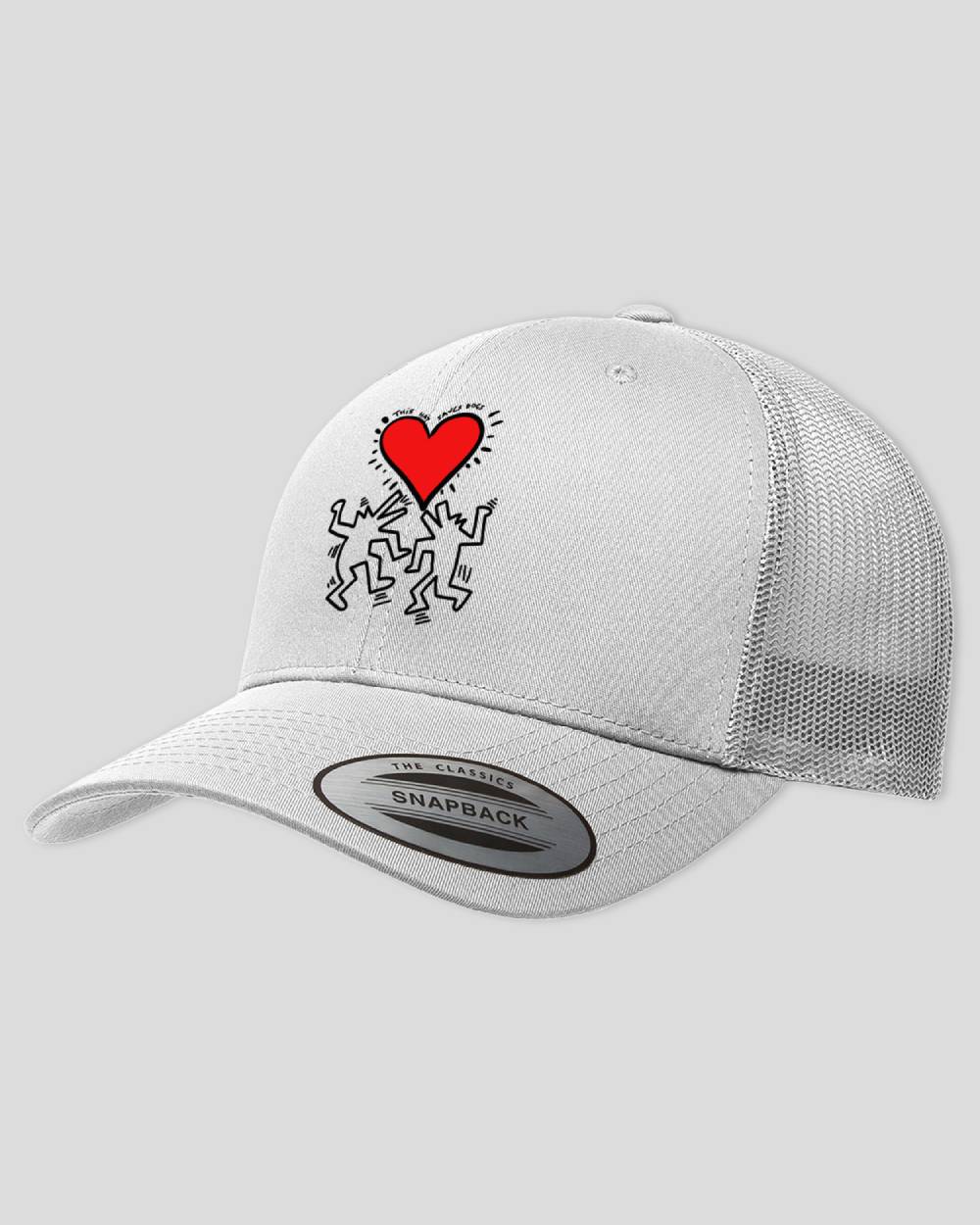 White trucker cap with a this saves dog design on it in the style of Keith Haring.